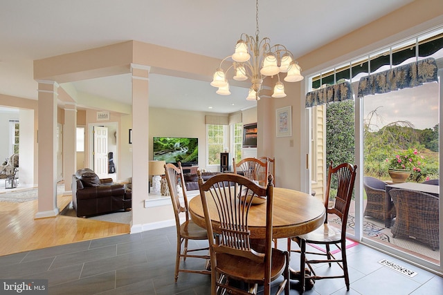 dining space featuring hardwood / wood-style floors and a notable chandelier