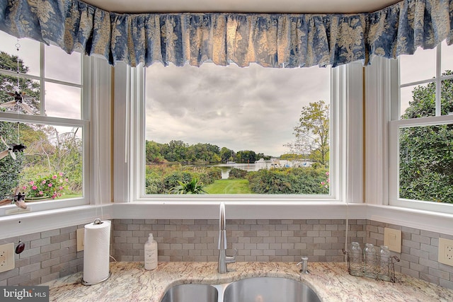 room details featuring sink and light stone counters