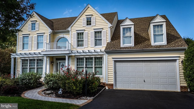 view of front of home featuring a balcony and a garage