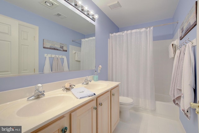 full bathroom with vanity, tile patterned flooring, toilet, and shower / tub combo