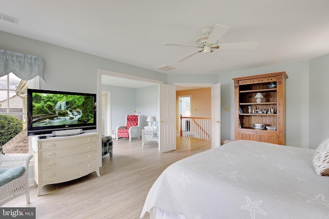 bedroom featuring multiple windows, light hardwood / wood-style floors, and ceiling fan