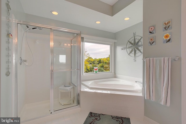 bathroom featuring tile patterned flooring and separate shower and tub