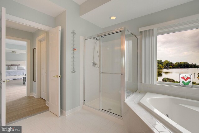 bathroom featuring ceiling fan, independent shower and bath, and tile patterned flooring