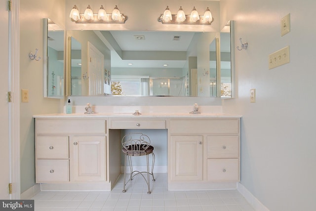 bathroom with vanity, a shower with shower door, and tile patterned floors