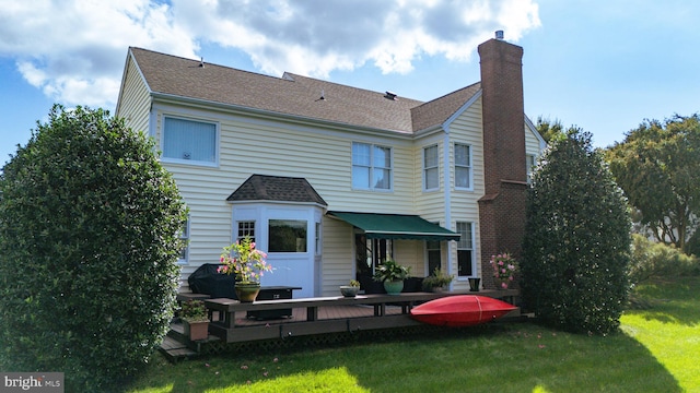 back of house featuring a yard and a deck