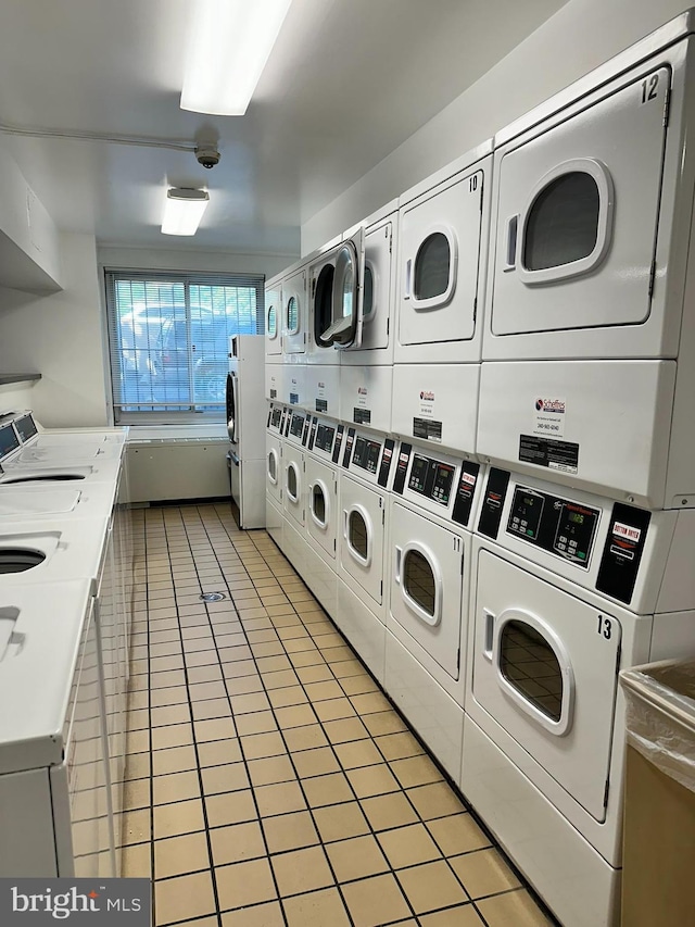 washroom featuring washer and clothes dryer, stacked washer / drying machine, and light tile patterned flooring