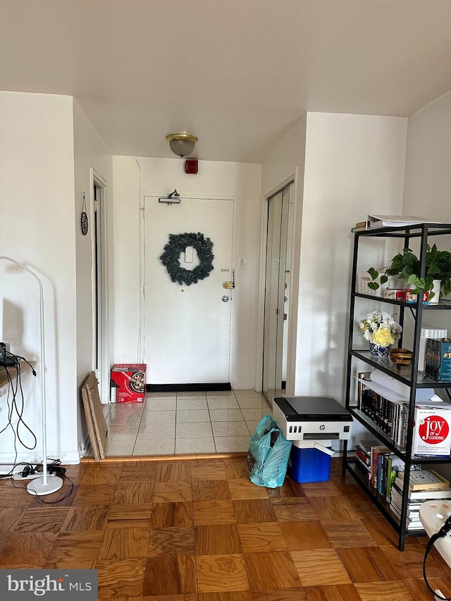 doorway to outside with tile patterned floors