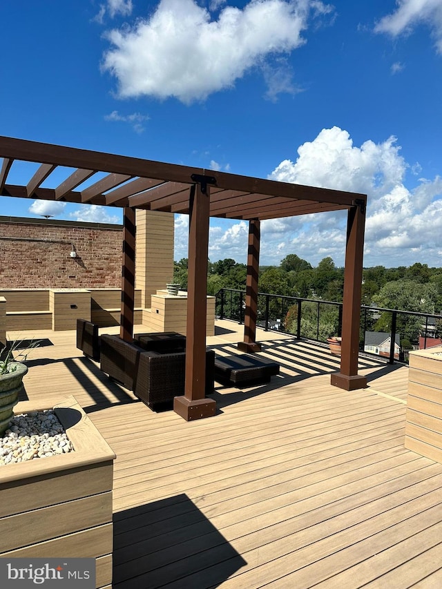 wooden deck featuring a pergola and an outdoor hangout area