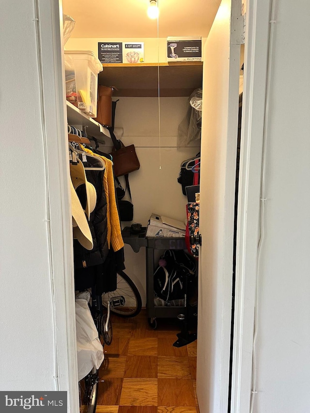 spacious closet featuring parquet flooring