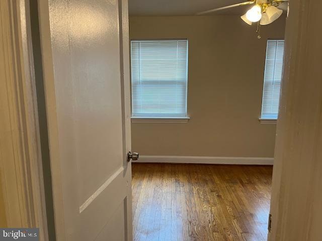 empty room featuring ceiling fan and hardwood / wood-style floors