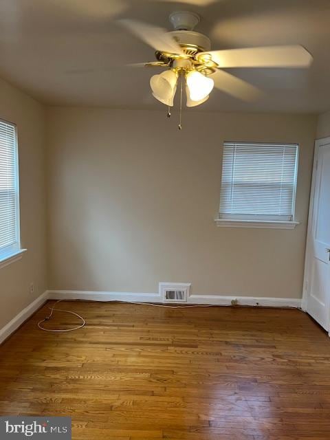 unfurnished room with wood-type flooring and ceiling fan