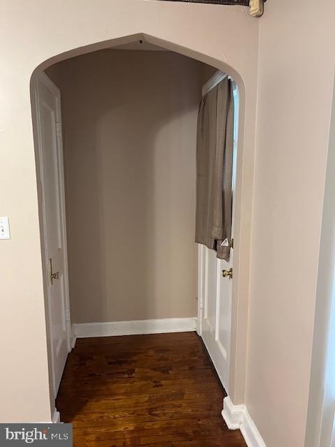 corridor with dark hardwood / wood-style floors