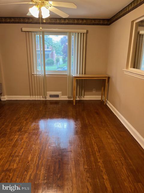 spare room featuring ceiling fan and dark hardwood / wood-style flooring