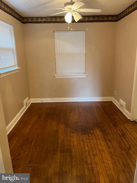 unfurnished room featuring hardwood / wood-style flooring and ceiling fan