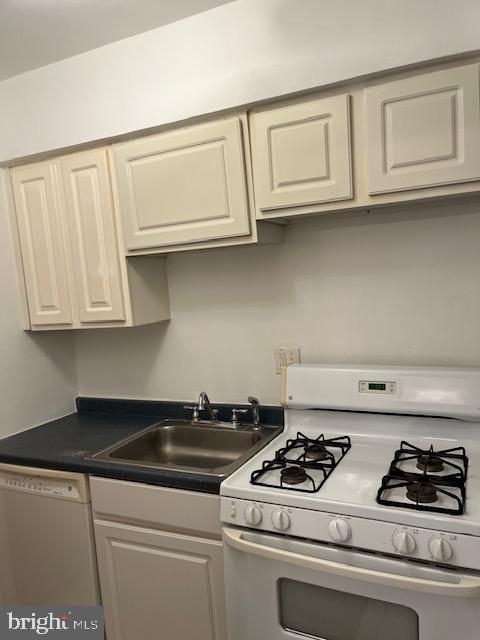 kitchen with sink and white appliances