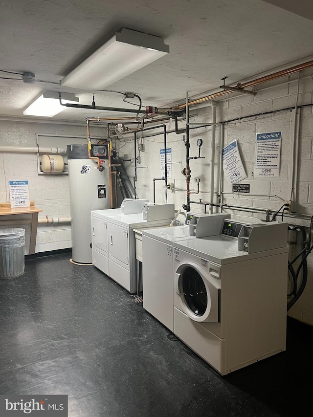 clothes washing area with water heater and independent washer and dryer