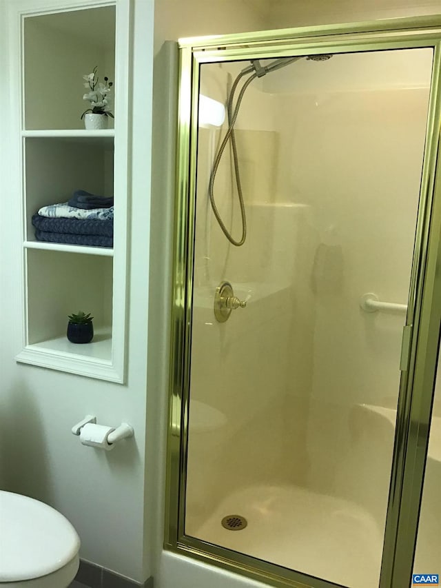 bathroom with toilet and walk in shower