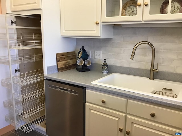 kitchen featuring sink, tasteful backsplash, white cabinetry, and dishwasher