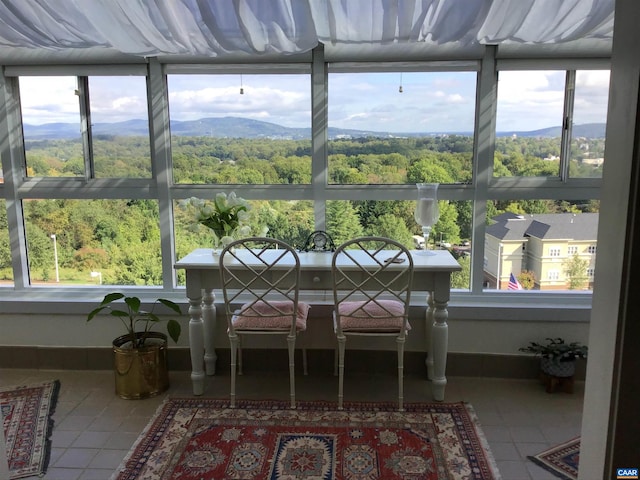 sunroom featuring a mountain view