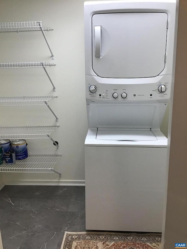 laundry area with stacked washer and clothes dryer