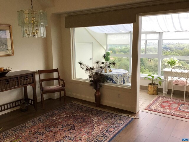 sitting room featuring a chandelier and wood-type flooring