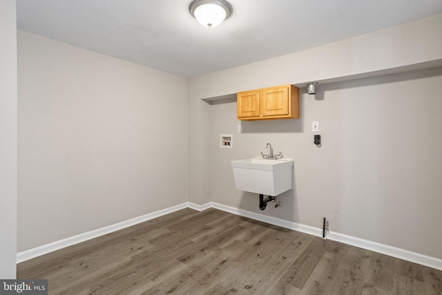 washroom with cabinets, dark hardwood / wood-style floors, hookup for a washing machine, and sink