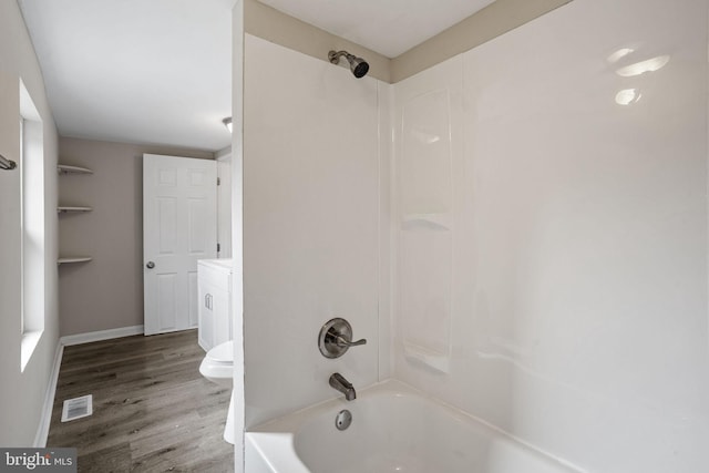 full bathroom featuring vanity, hardwood / wood-style flooring, tub / shower combination, and toilet