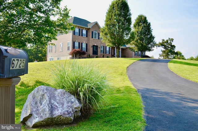 colonial home with a front yard