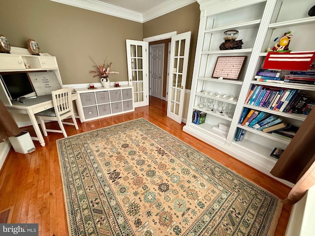 sitting room featuring ornamental molding and hardwood / wood-style floors