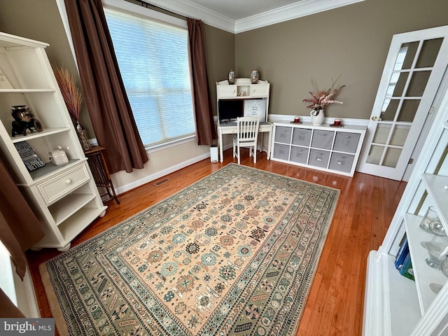 home office with ornamental molding and hardwood / wood-style flooring