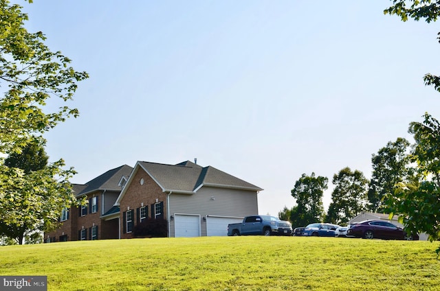 view of side of home with a yard and a garage