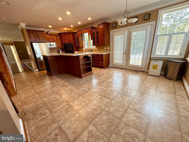 kitchen with oven, crown molding, a center island, a notable chandelier, and stainless steel refrigerator