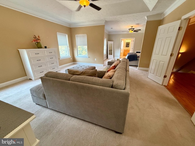 carpeted living room featuring ornamental molding, a textured ceiling, and ceiling fan