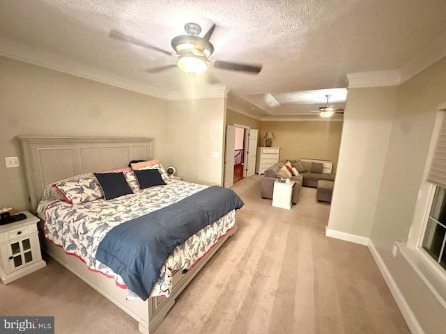 bedroom featuring ornamental molding, a textured ceiling, light colored carpet, and ceiling fan