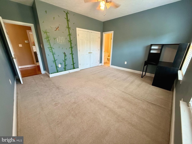 unfurnished bedroom with ceiling fan, light carpet, and a textured ceiling