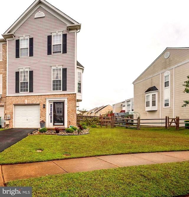 view of front of property featuring a garage and a front yard