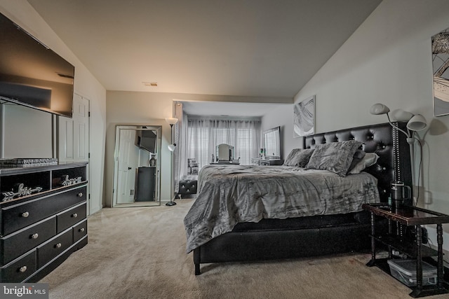 bedroom featuring light carpet and lofted ceiling