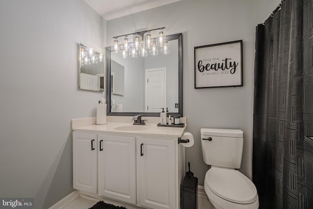 bathroom with tile patterned floors, vanity, and toilet