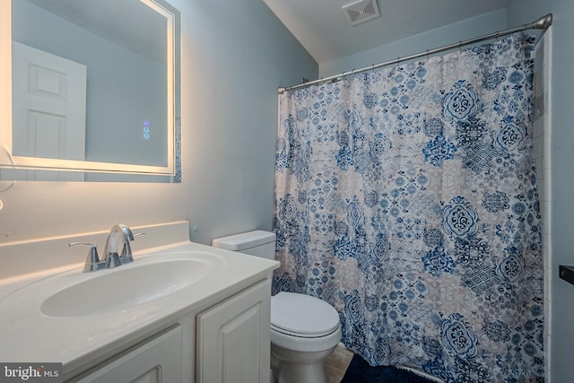 bathroom featuring curtained shower, vanity, toilet, and tile patterned floors