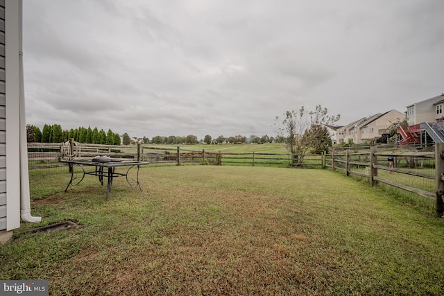 view of yard with a rural view