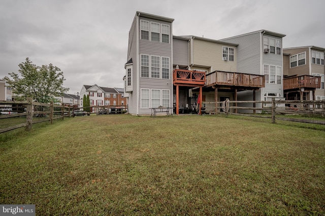 back of property featuring a deck and a yard