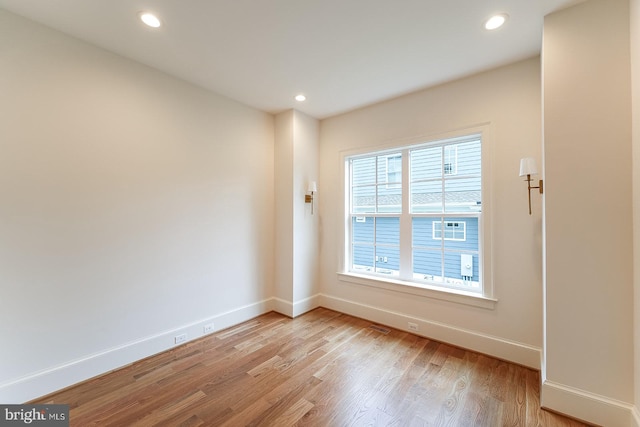 unfurnished room with light hardwood / wood-style flooring