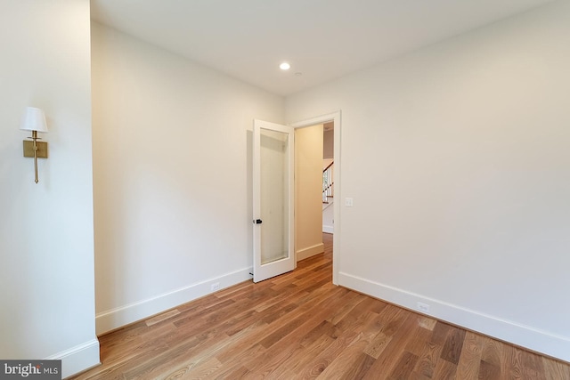 spare room with light hardwood / wood-style flooring