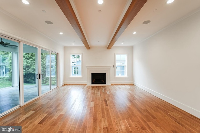 unfurnished living room featuring crown molding, light hardwood / wood-style floors, and beamed ceiling