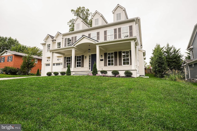 view of front of home featuring a garage, a front lawn, and covered porch