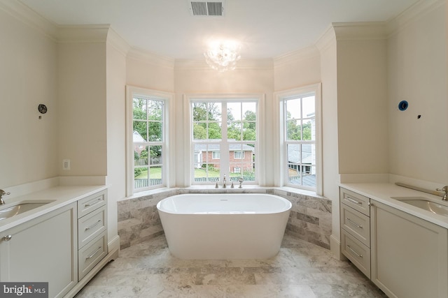 bathroom featuring ornamental molding, vanity, a tub, and a notable chandelier