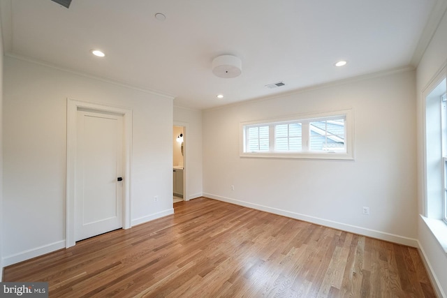 interior space featuring crown molding and light hardwood / wood-style floors