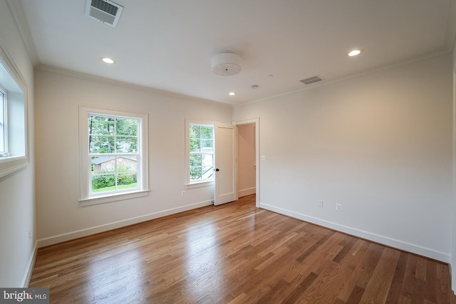 unfurnished room with crown molding and hardwood / wood-style floors