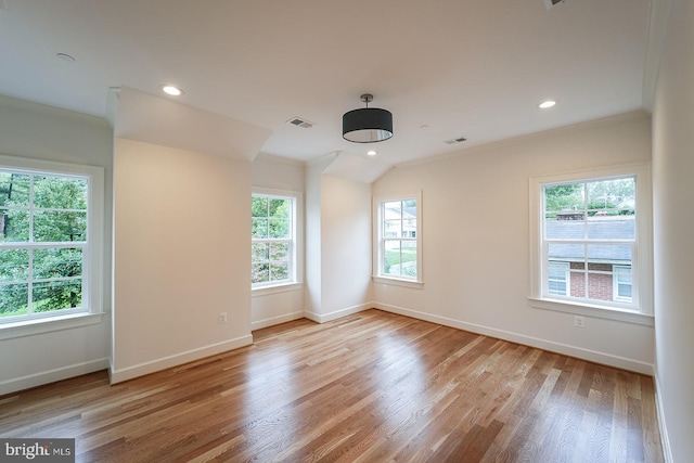 unfurnished room featuring ornamental molding and light hardwood / wood-style flooring