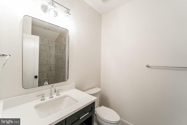 bathroom with vanity, toilet, and an enclosed shower